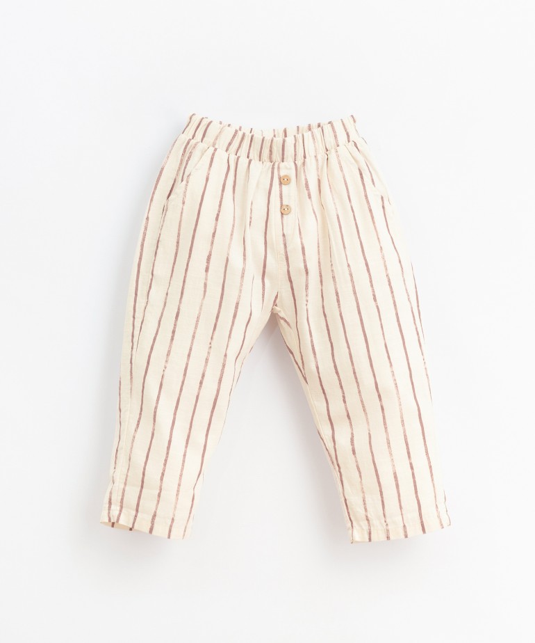 Fabric pants with decorative buttons