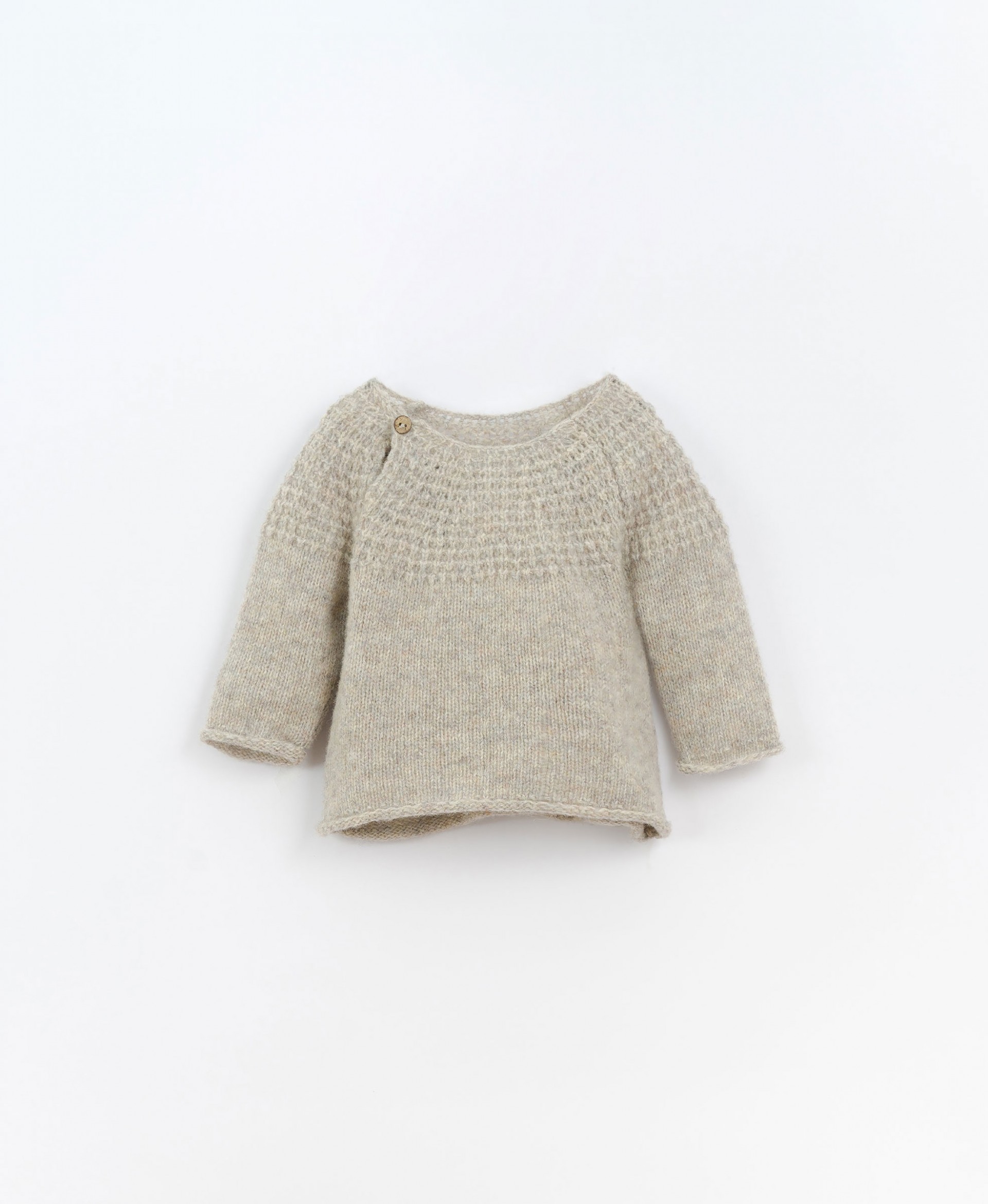 Knitted jersey with coconut button | Culinary