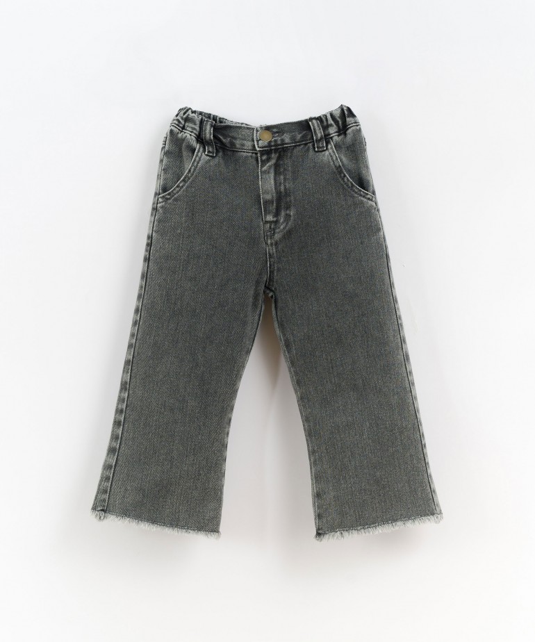 Denim trousers with frayed hem