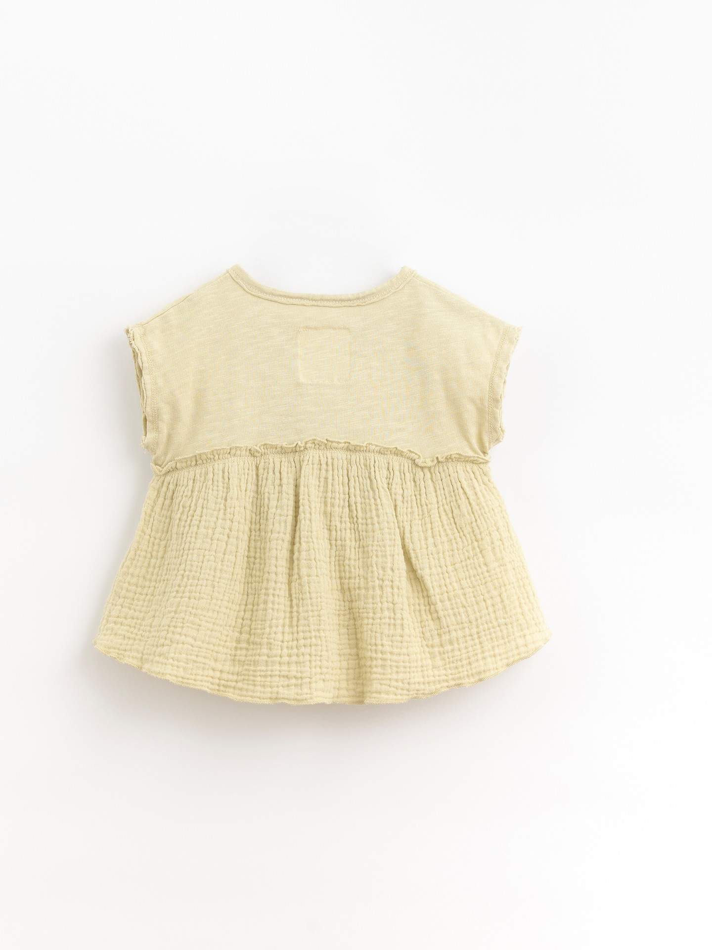 Tunic with coconut button opening