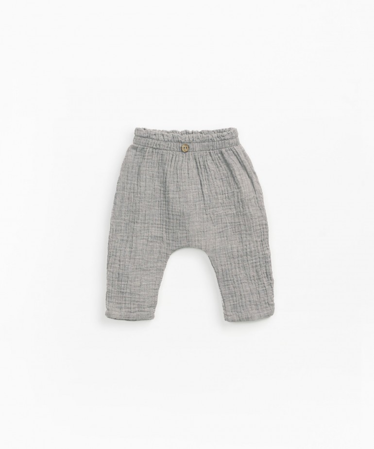 Woven trousers with decorative button