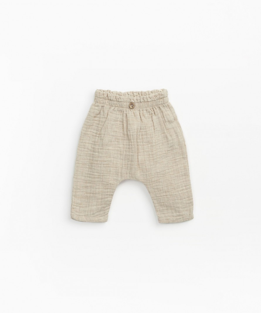 Woven trousers with decorative button
