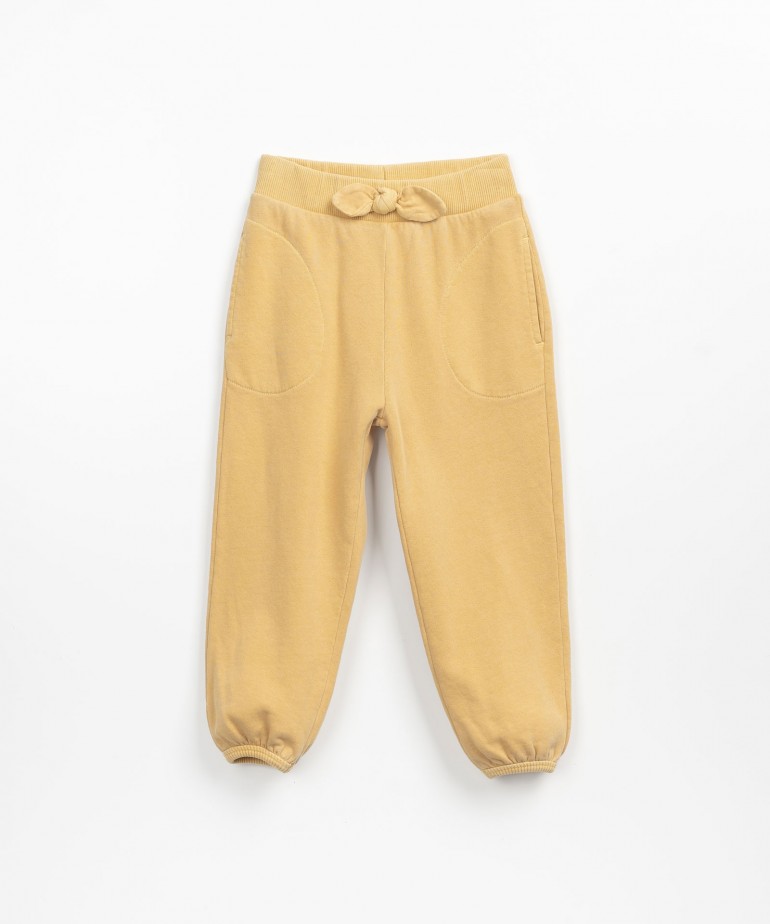 Trousers with decorative bow