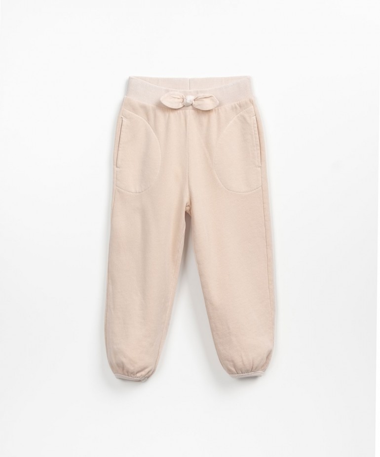Trousers with decorative bow