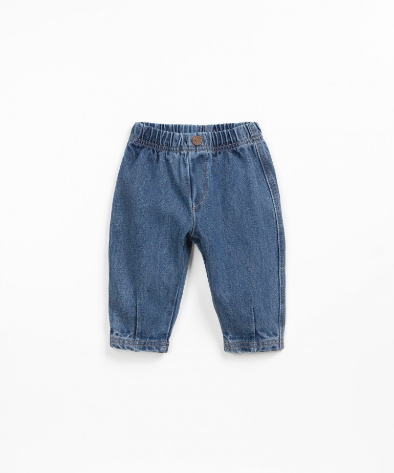 Denim pants with decorative button