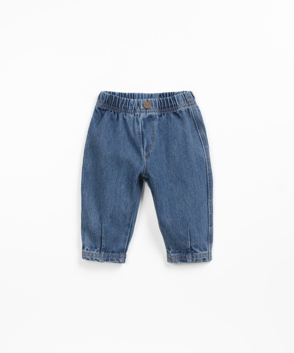 Denim pants with decorative button