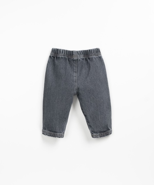 Denim pants with decorative button