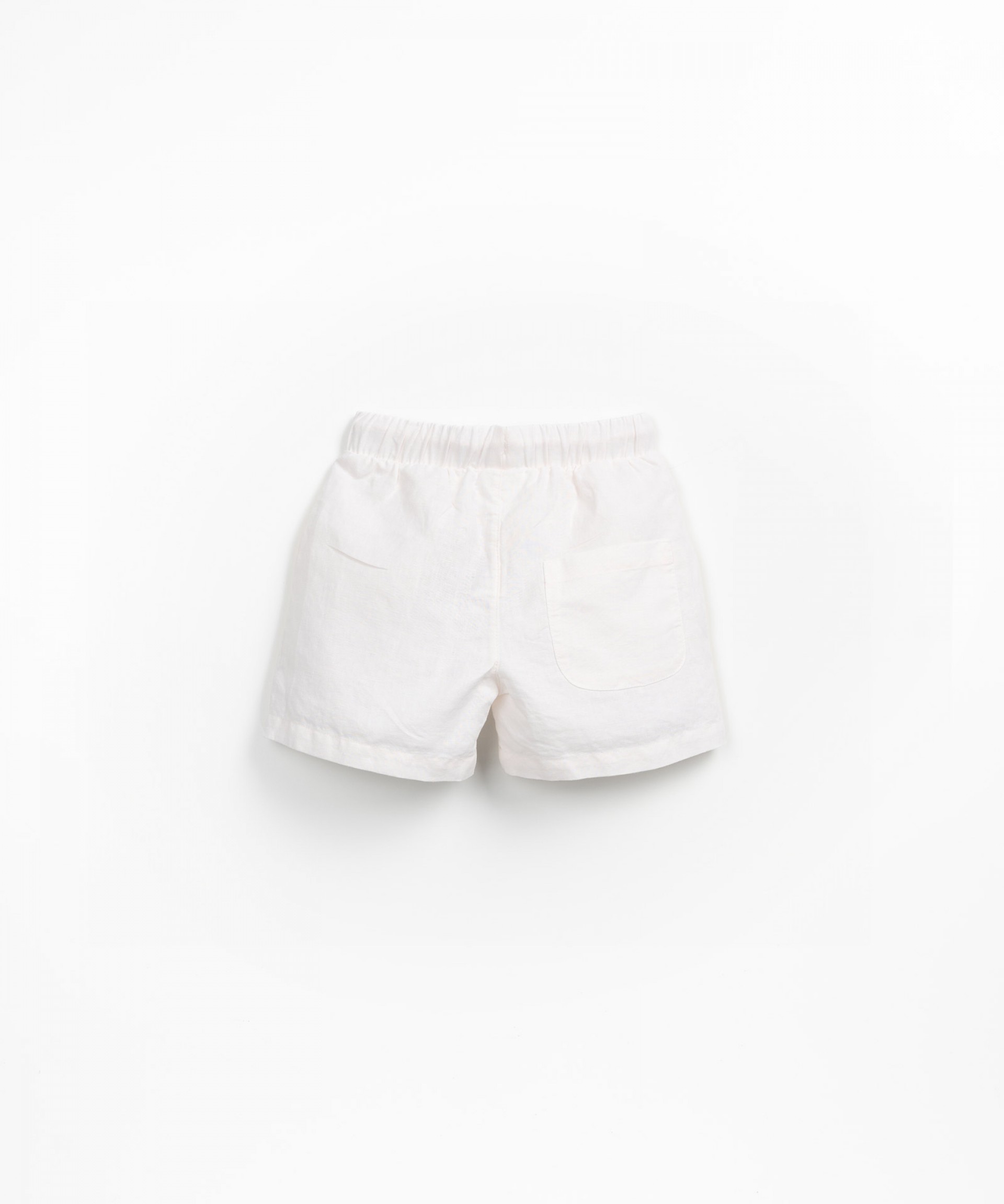 Fabric shorts with decorative coconut button