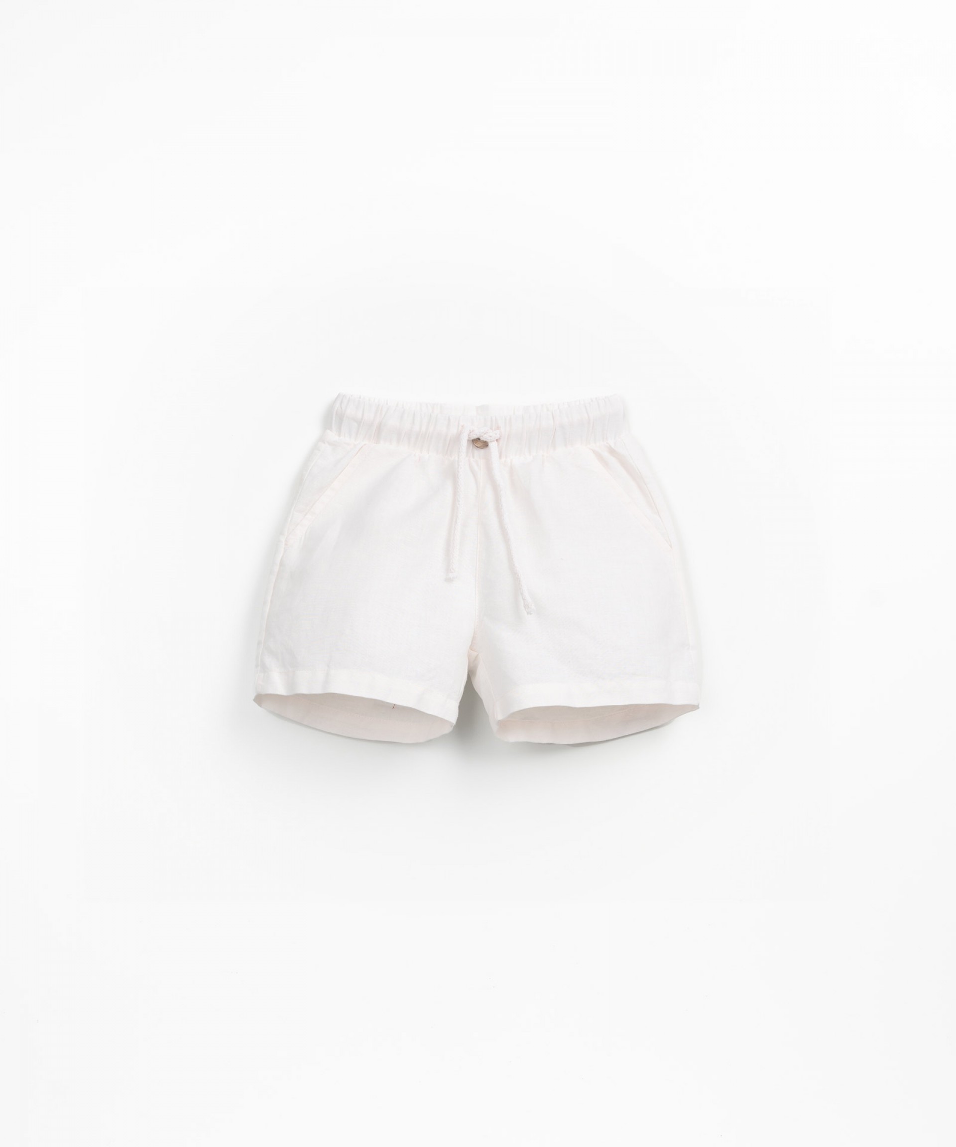 Fabric shorts with decorative coconut button