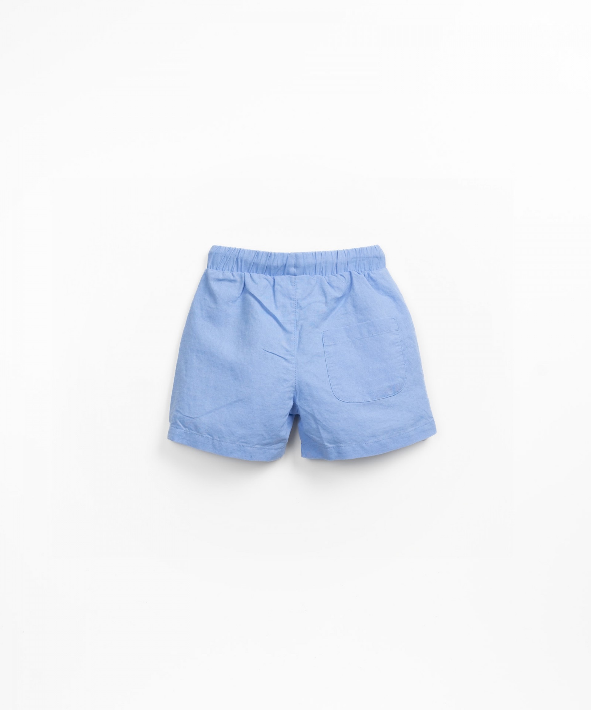 Fabric shorts with decorative coconut button