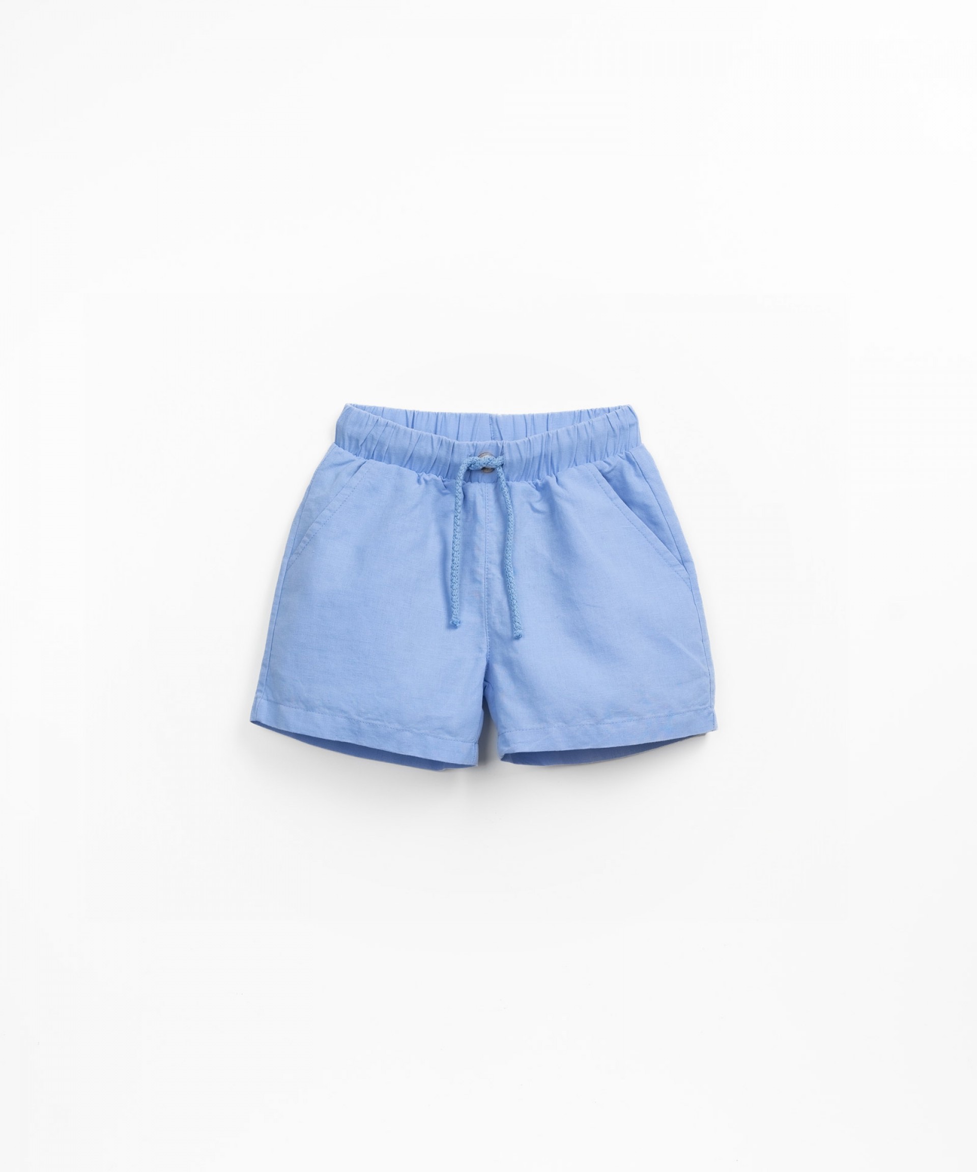 Fabric shorts with decorative coconut button