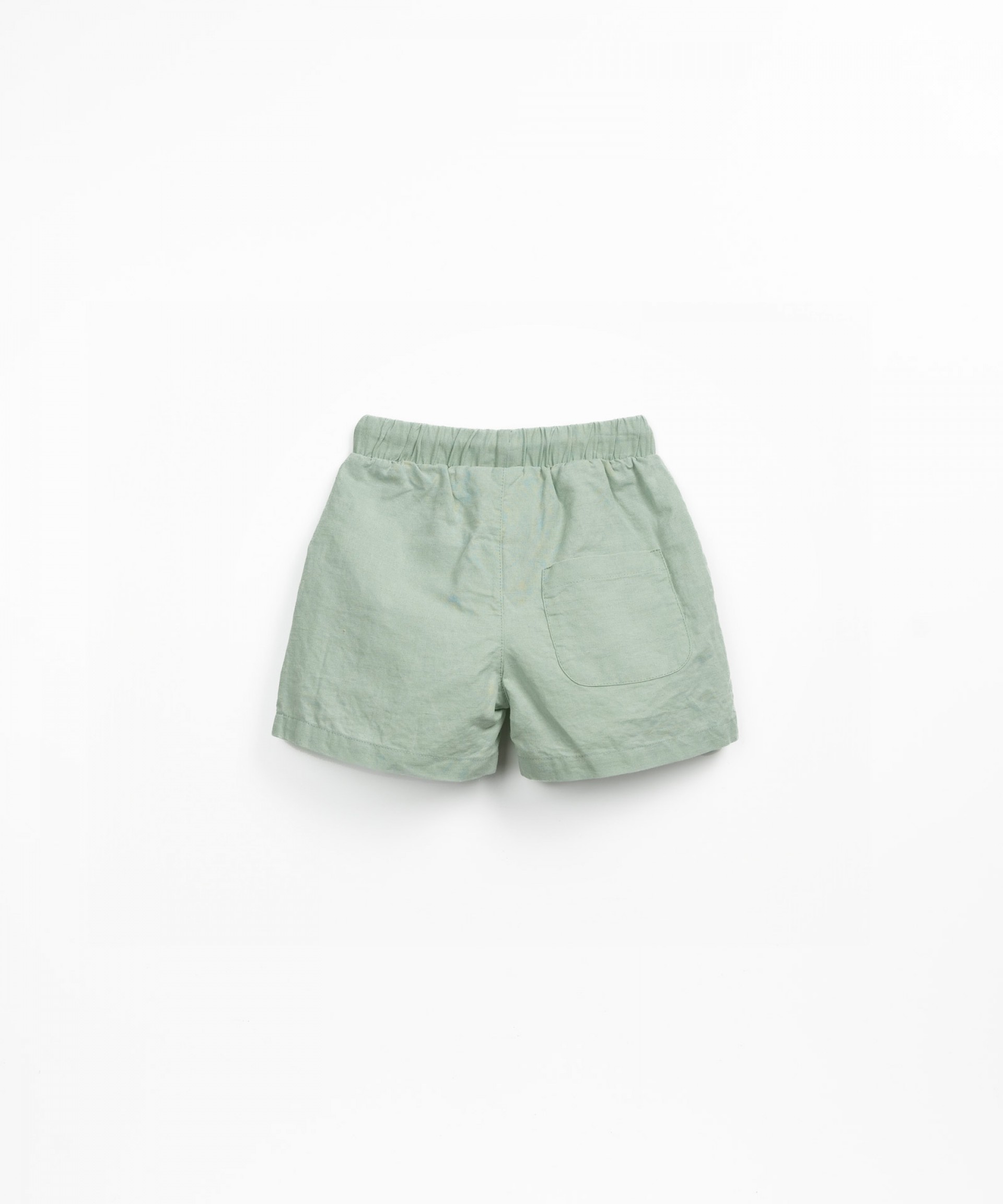 Pantaln corto de tela con botn de coco decorativo