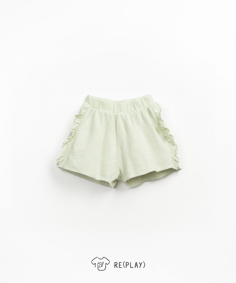 Shorts with side fringes and organic cotton blend