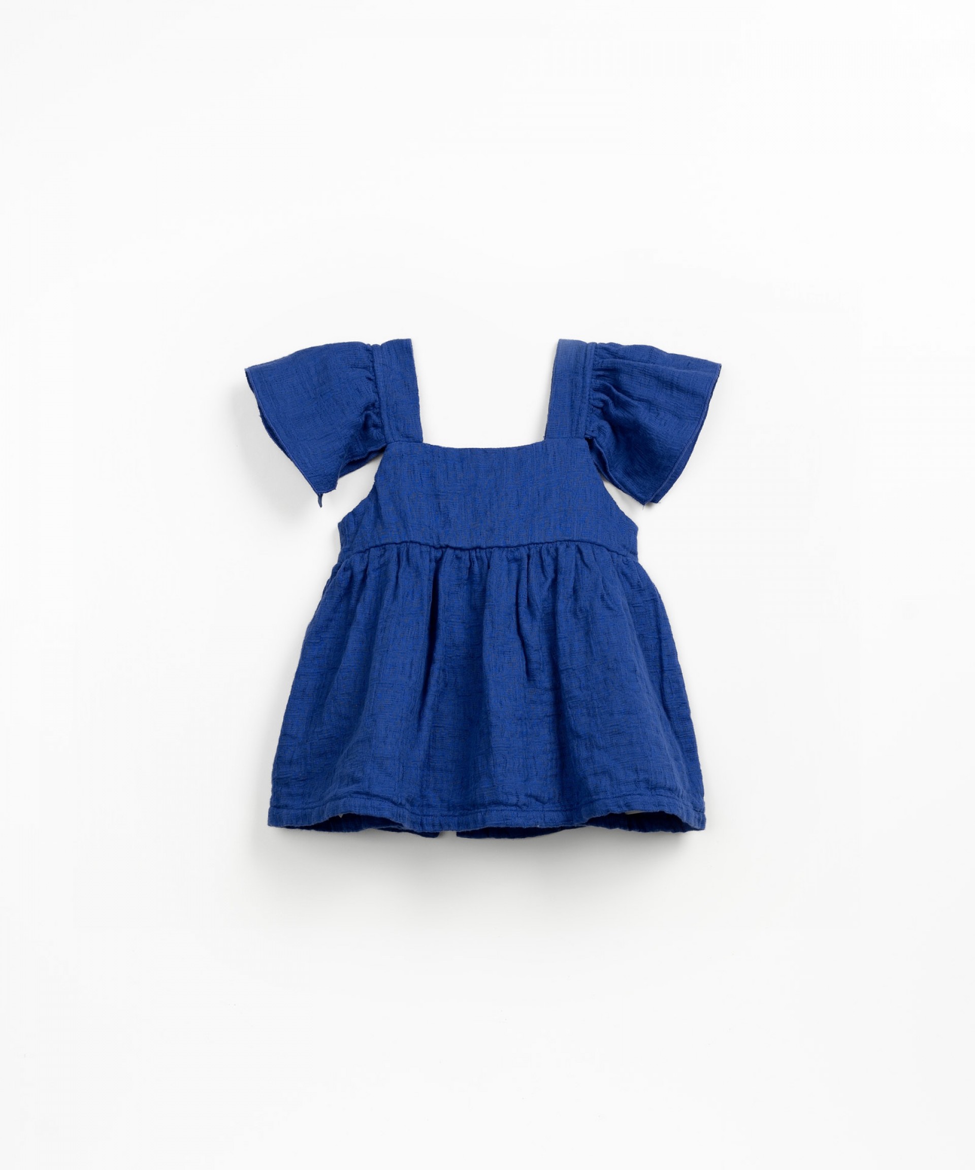 Tunic with opening at the back