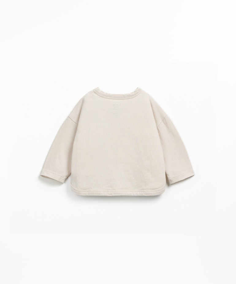 Knit sweater with a blend of natural and recycled fibers