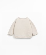 Knit sweater with shoulder opening