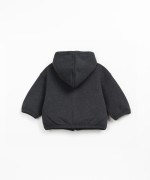 Fleece jacket in recycled cotton with hood, front fastening and side pockets