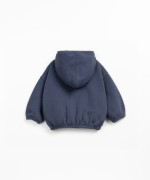 Fleece jacket in recycled cotton with hood, front zipper, and side pockets