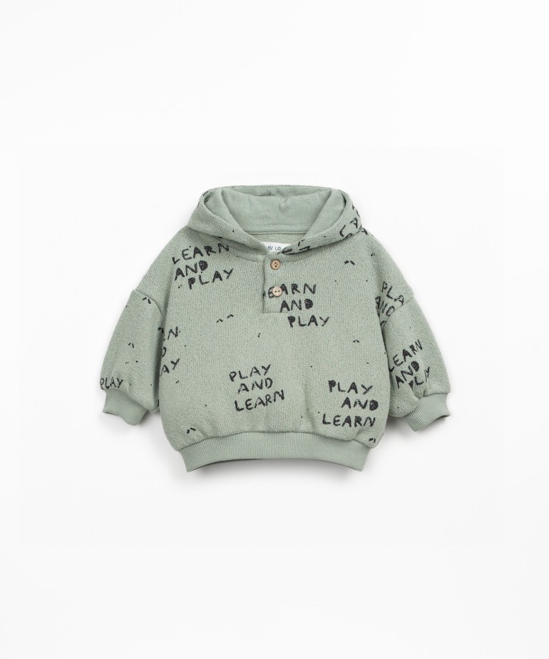 Knitted sweater with blend of natural and recycled fibers