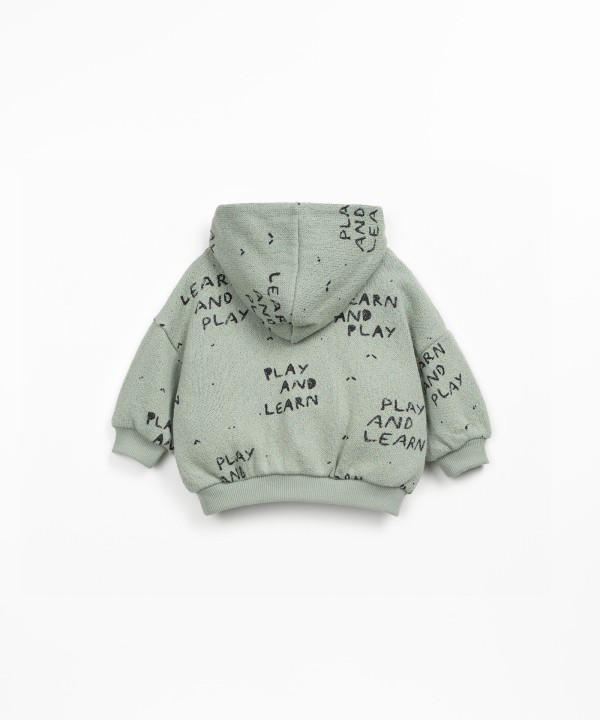 Knitted sweater with blend of natural and recycled fibers