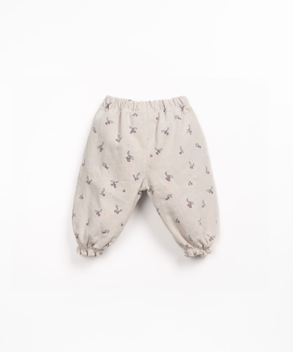 Printed cotton twill trousers with strawberry tree pattern