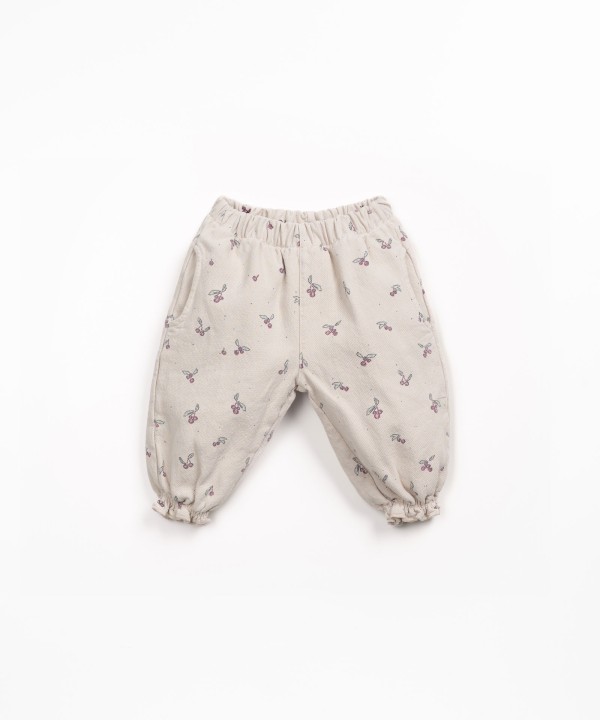 Printed cotton twill trousers with strawberry tree pattern