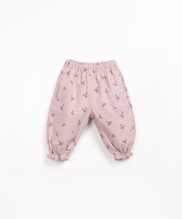 Printed cotton twill trousers with strawberry tree pattern