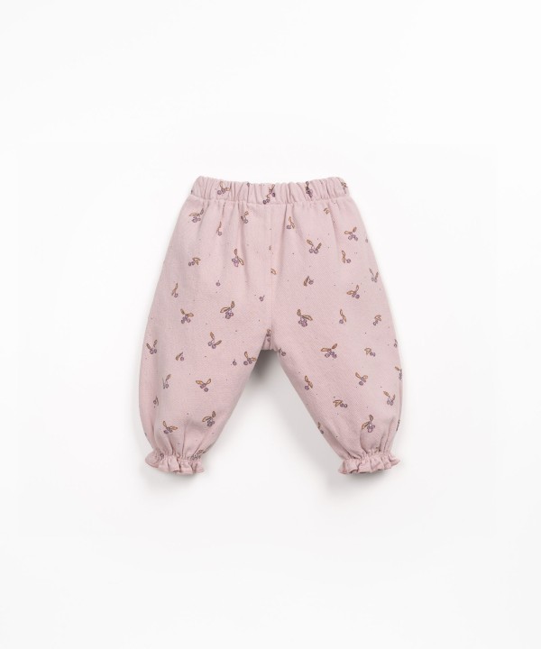 Printed cotton twill trousers with strawberry tree pattern