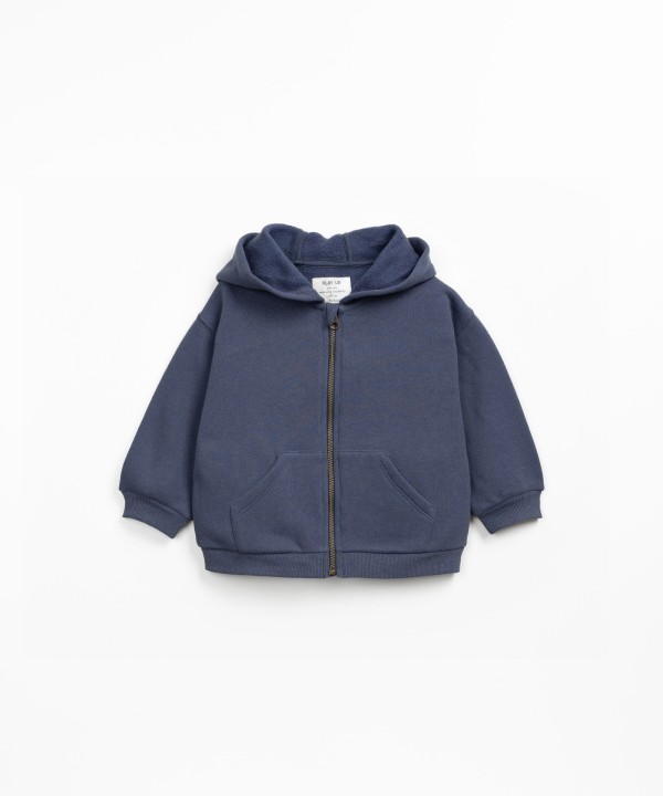 Fleece jacket with hood and zip fastening