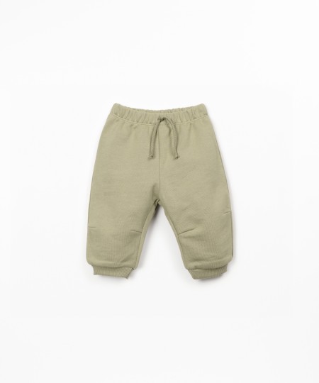 Trousers with decorative drawstring