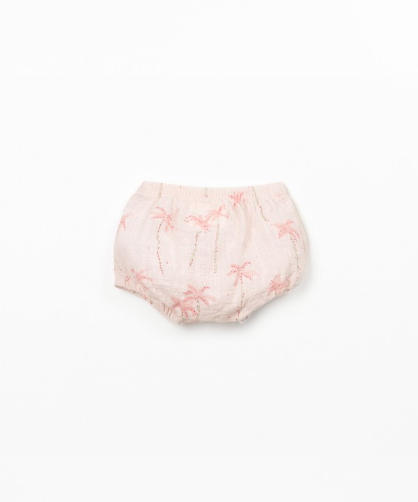 Cal��o de algod�o org�nico com estampado de palmeiras