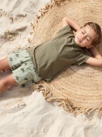 Cal��o de tecido com estampado de palmeiras