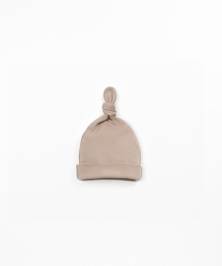 Knit beanie with decorative knot