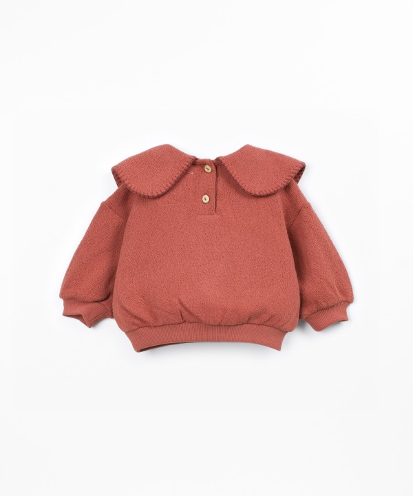 Knit sweater with recycled fibers