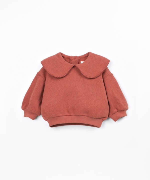 Knit sweater with recycled fibers