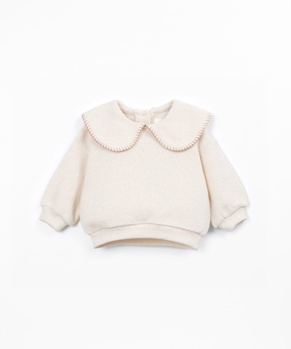 Knit sweater with recycled fibers